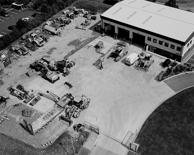 Aerial view of an industrial outdoor storage yard with heavy equipment